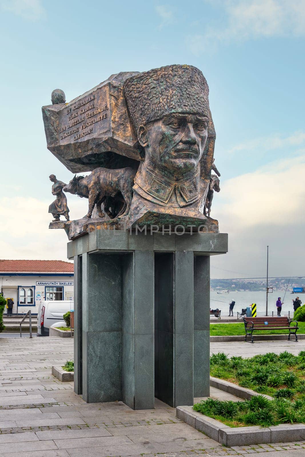 Istanbul, Turkey - May 12, 2023: Bronze statue on a tall pillar of founder of Turkish Republic, Mustafa Kemal Ataturk in a thoughtful pose, with Bosphorus in the background, in Arnavutkoy