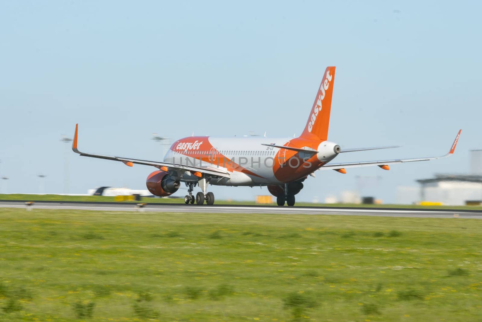 1 December 2022 PORTUGAL, LISBON: EASYJET OE-IJX airplane gaining speed on the runway. Mid shot