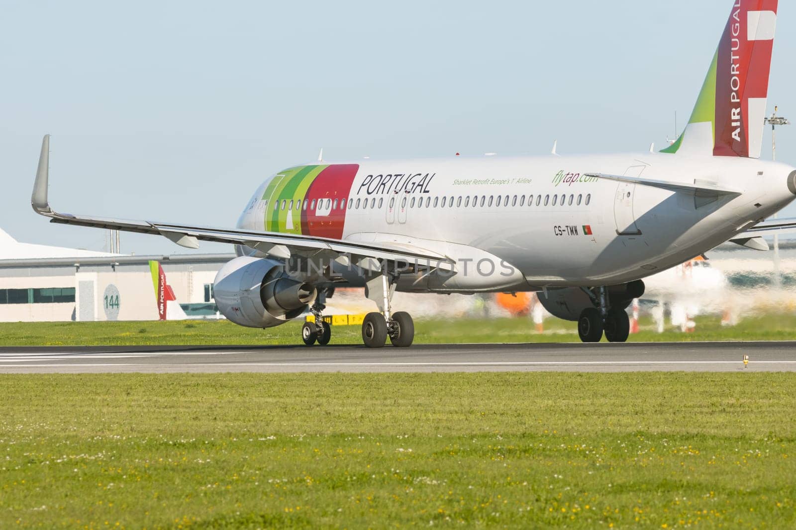 1 December 2022 PORTUGAL, LISBON: AIRPORTUGAL CS-TMW passenger plane on the runway. Mid shot