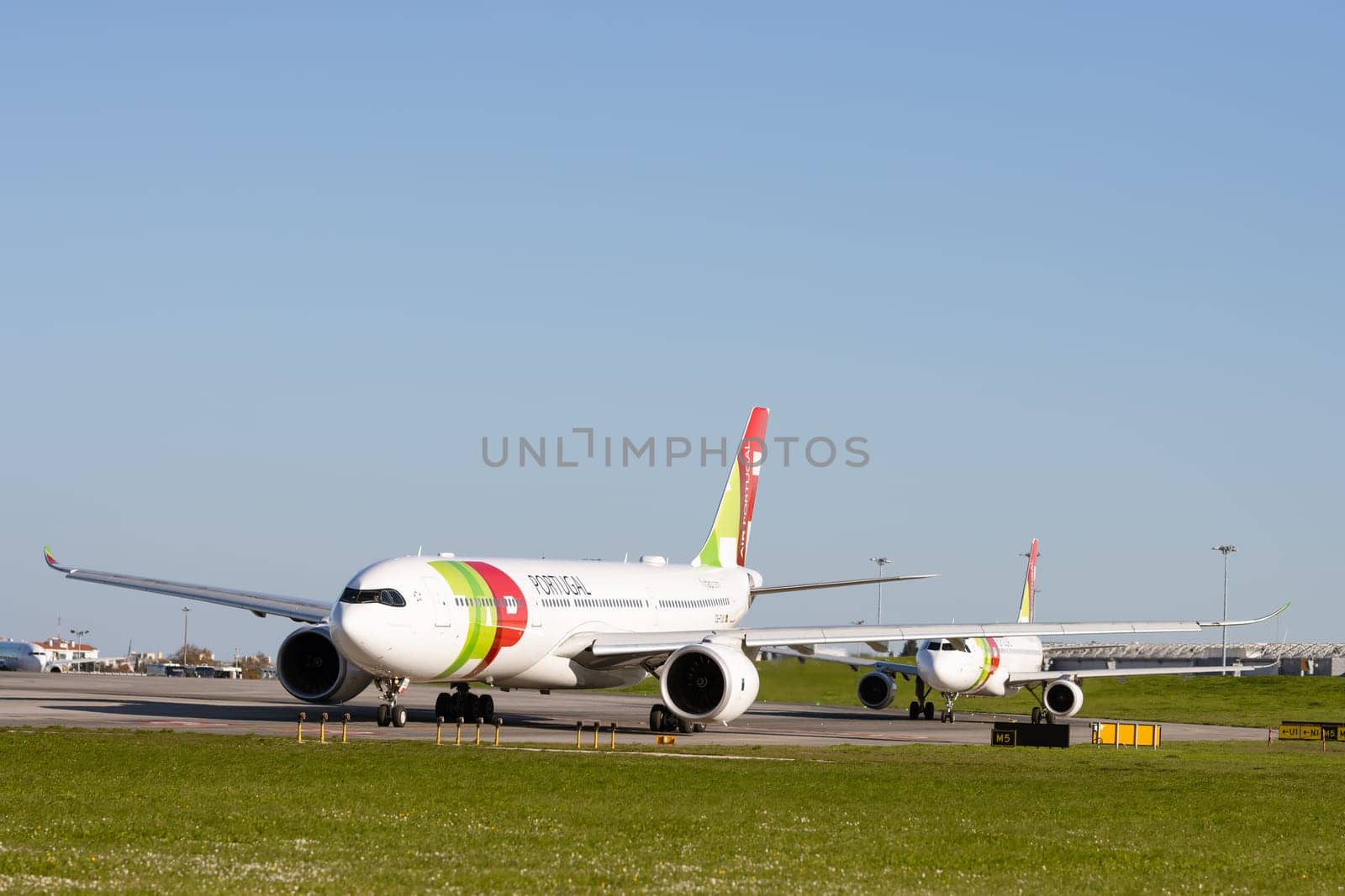 1 December 2022 PORTUGAL, LISBON: AIRPORTUGAL passenger planes standing on the field by the airport. Mid shot
