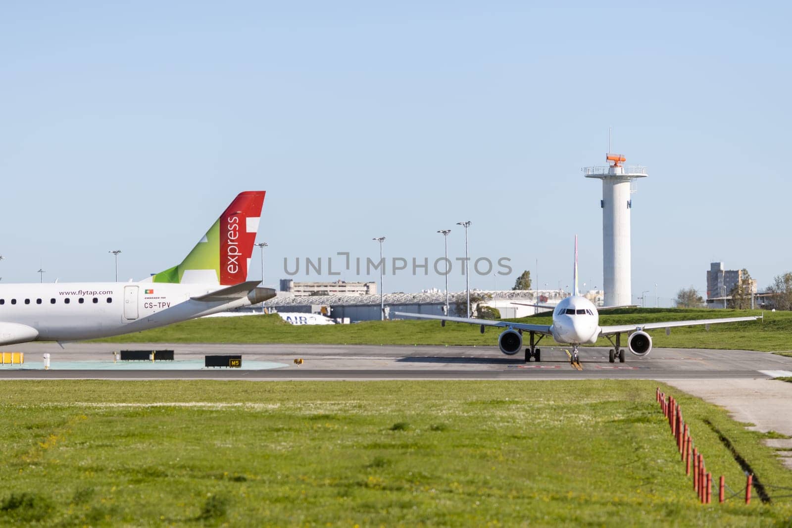 1 December 2022 PORTUGAL, LISBON: passenger planes parked on the airport field. Mid shot