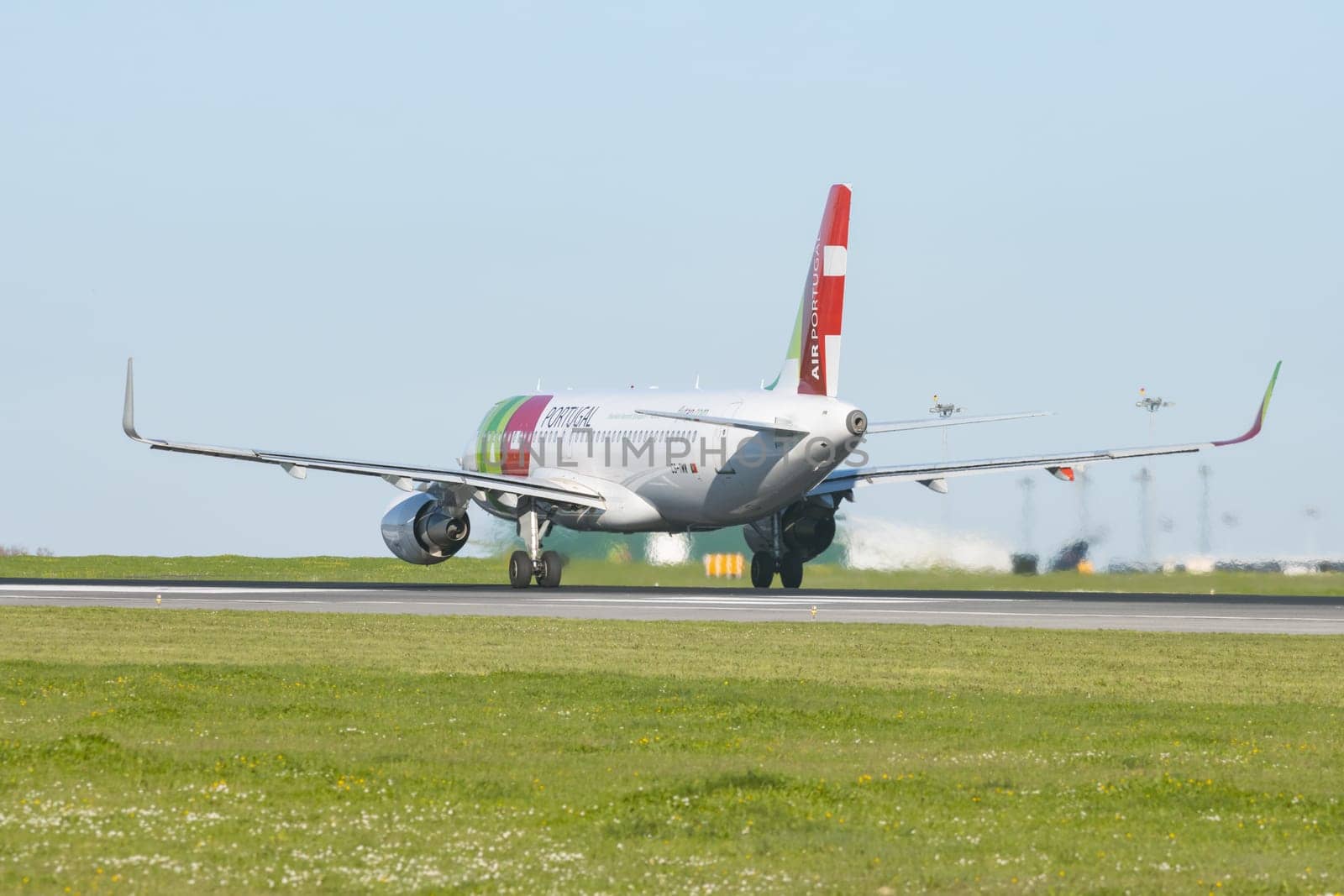 1 December 2022 PORTUGAL, LISBON: AIRPORTUGAL CS-TMW riding plane on the runway. Mid shot