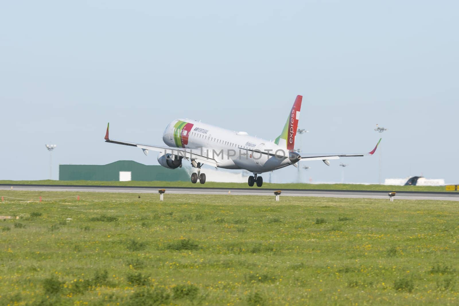 1 December 2022 PORTUGAL, LISBON: AIRPORTUGAL CS-TTY express airplane took off the runway. Mid shot