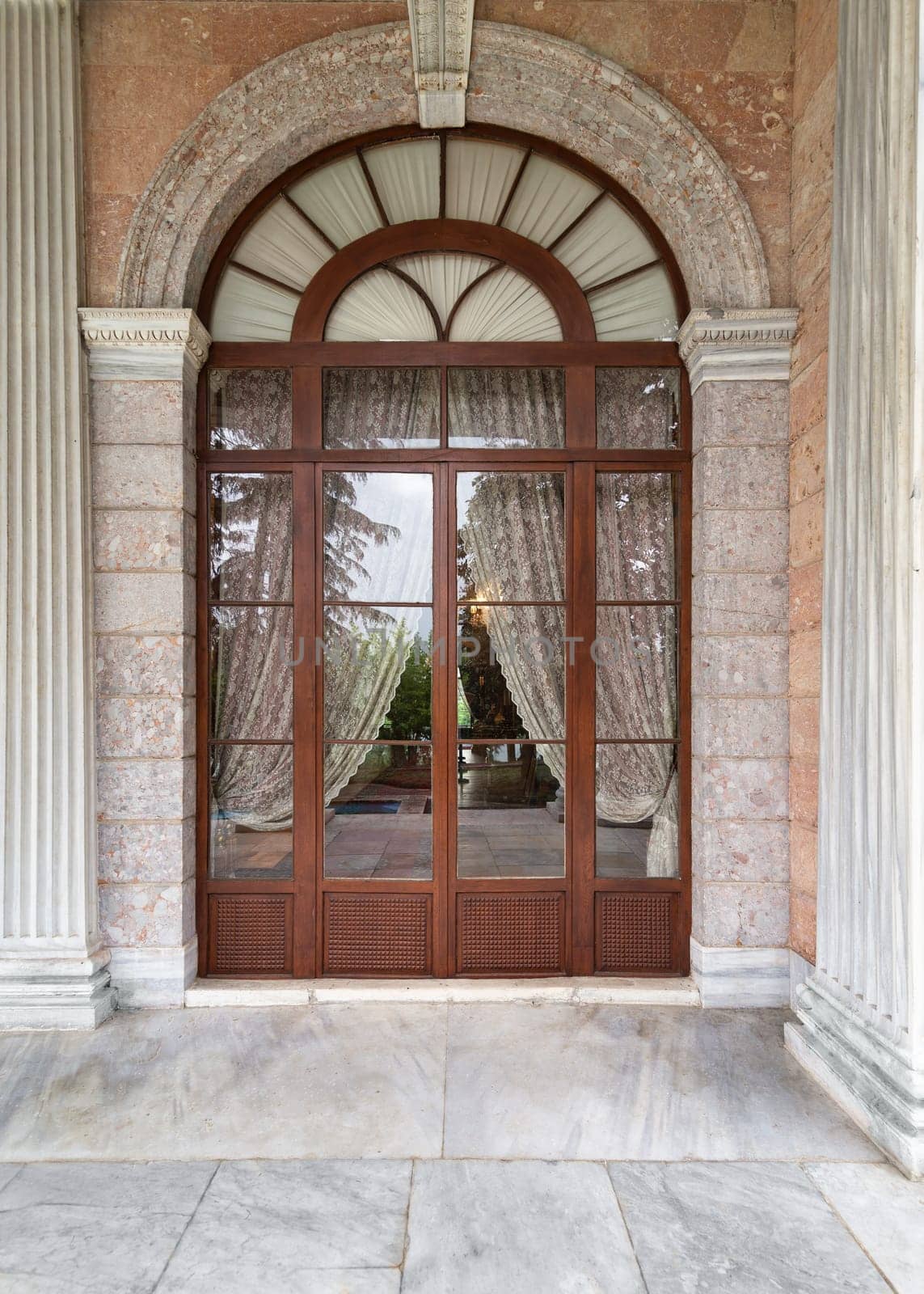 Grand entrance doorway leading to Beykoz Mecidiye Pavilion. The doorway is made of wood and glass and has ornate carvings