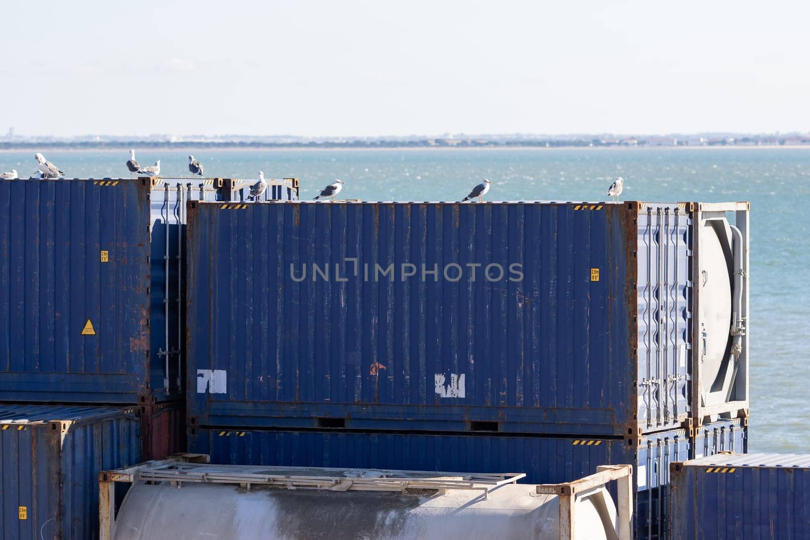 Blue cargo containers ready for loading in the seaport. Mid shot