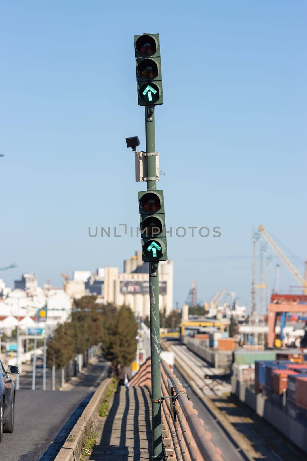 Green traffic light pointing forward at the cargo port. Mid shot