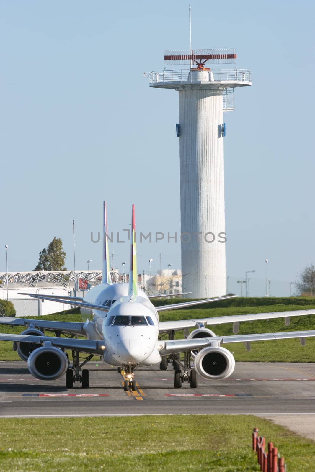 1 December 2022 PORTUGAL, LISBON: passenger planes stand in a row on a field near the airport. Vertical shot