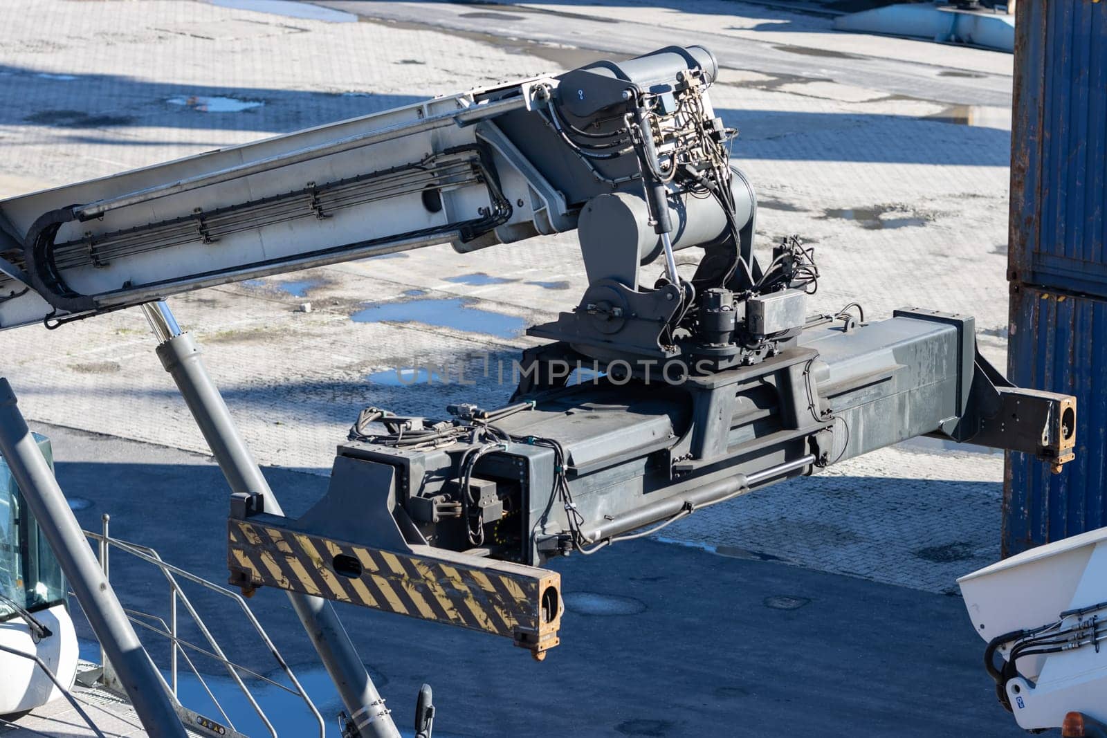 Big cargo spreader for container lifting at the seaport. Mid shot