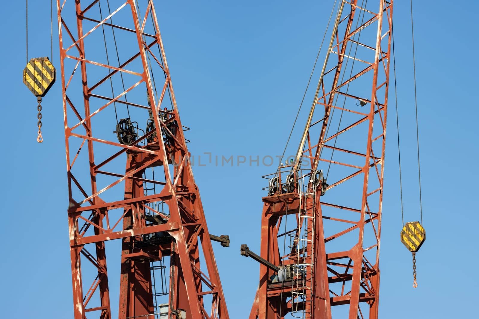 Cranes on the background of the blue sky. Mid shot