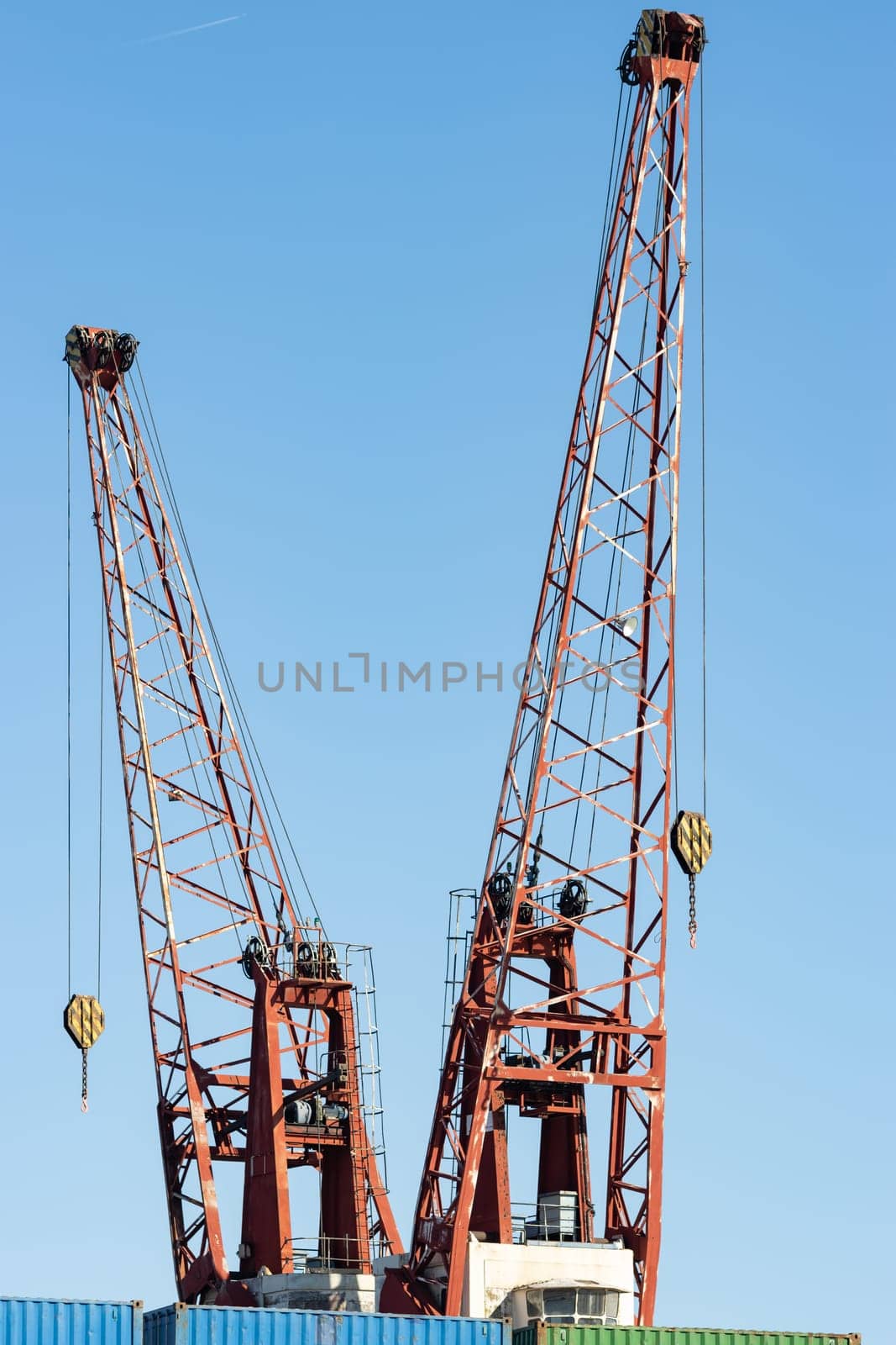 Cranes in the seaport for lifting cargo. Mid shot