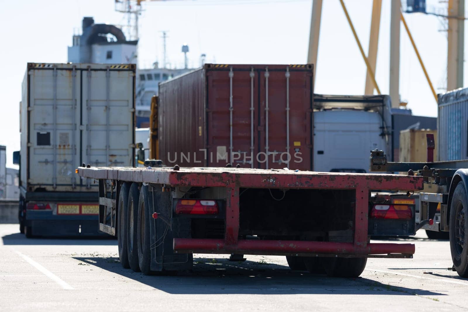 Trucks in the parking lot at the seaport are waiting for loading. Mid shot
