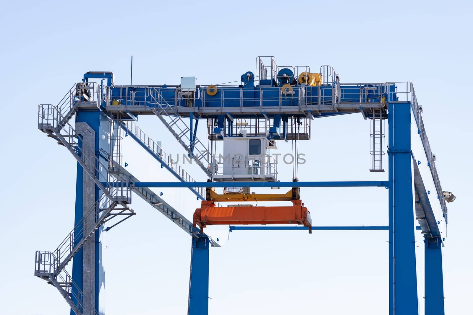 Suspended spreader for lifting cargo containers. Mid shot