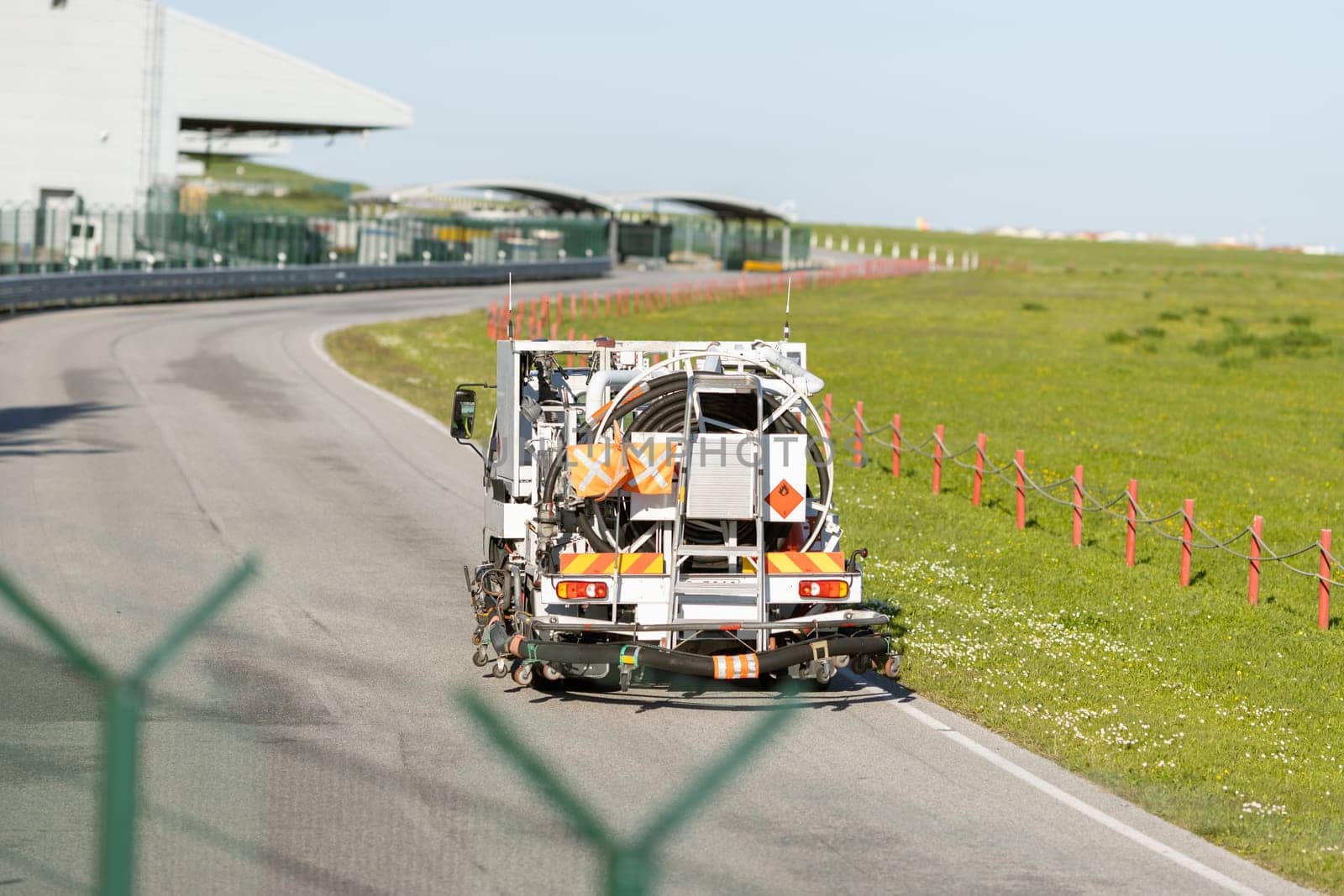 A truck carrying an explosive substance to a warehouse. Mid shot