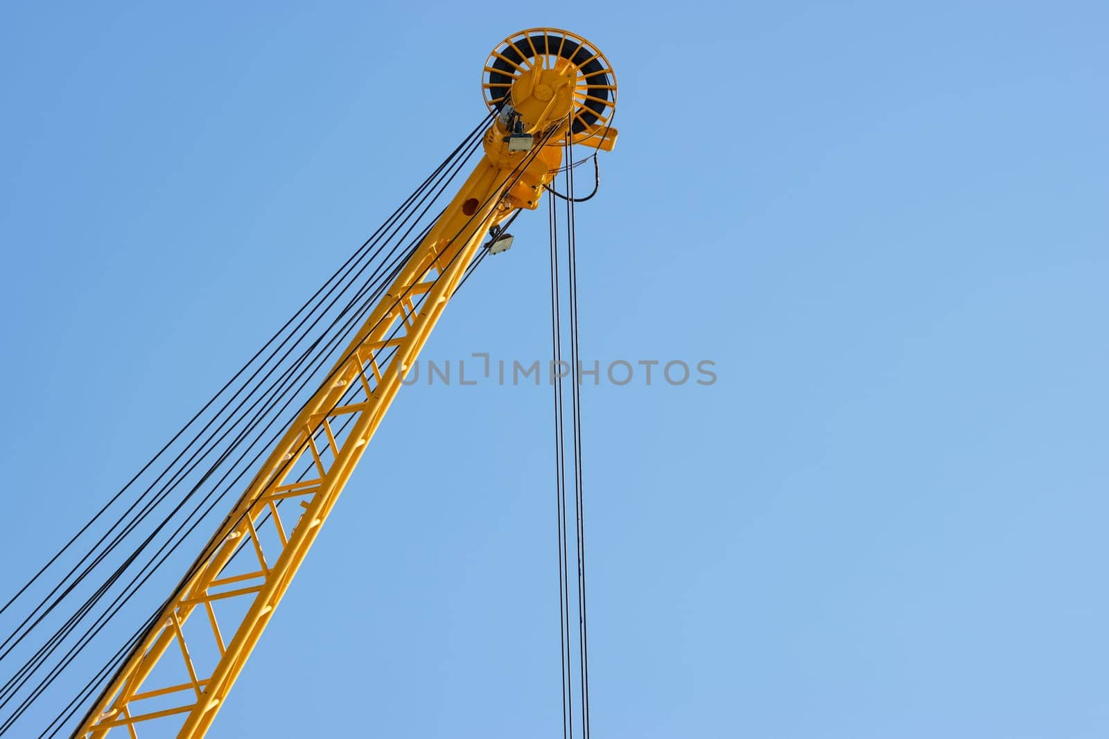 The coil of the yellow lifting crane. Mid shot