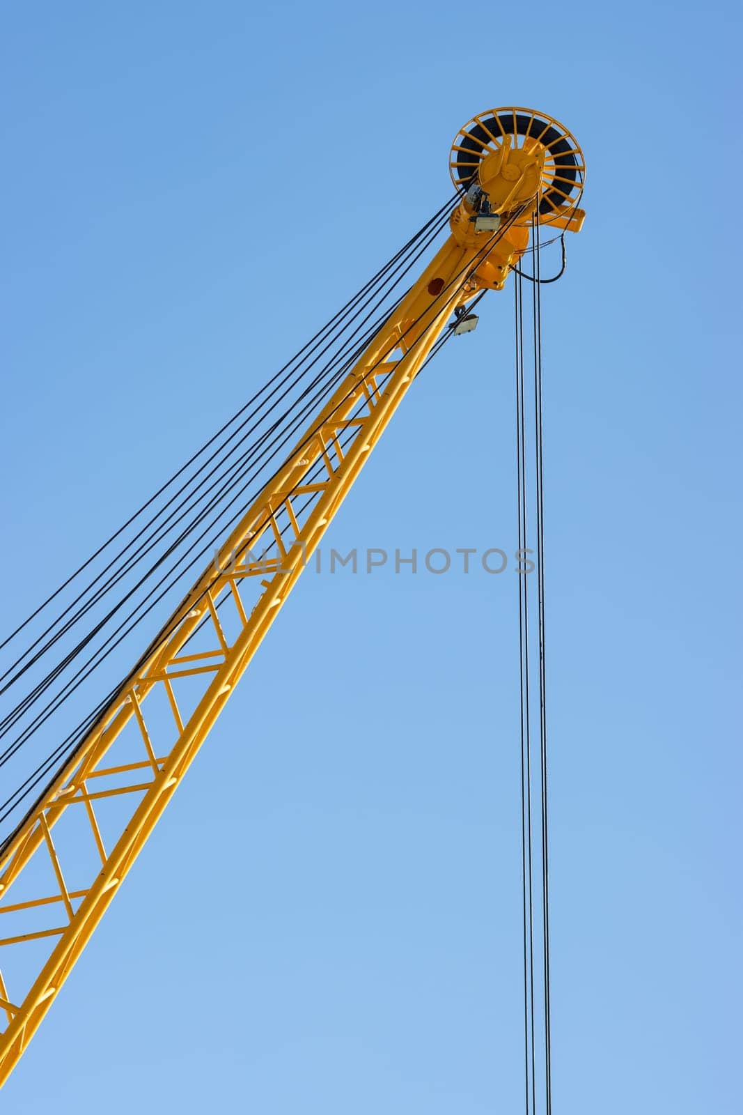 The coil of the yellow lifting crane. Vertical shot