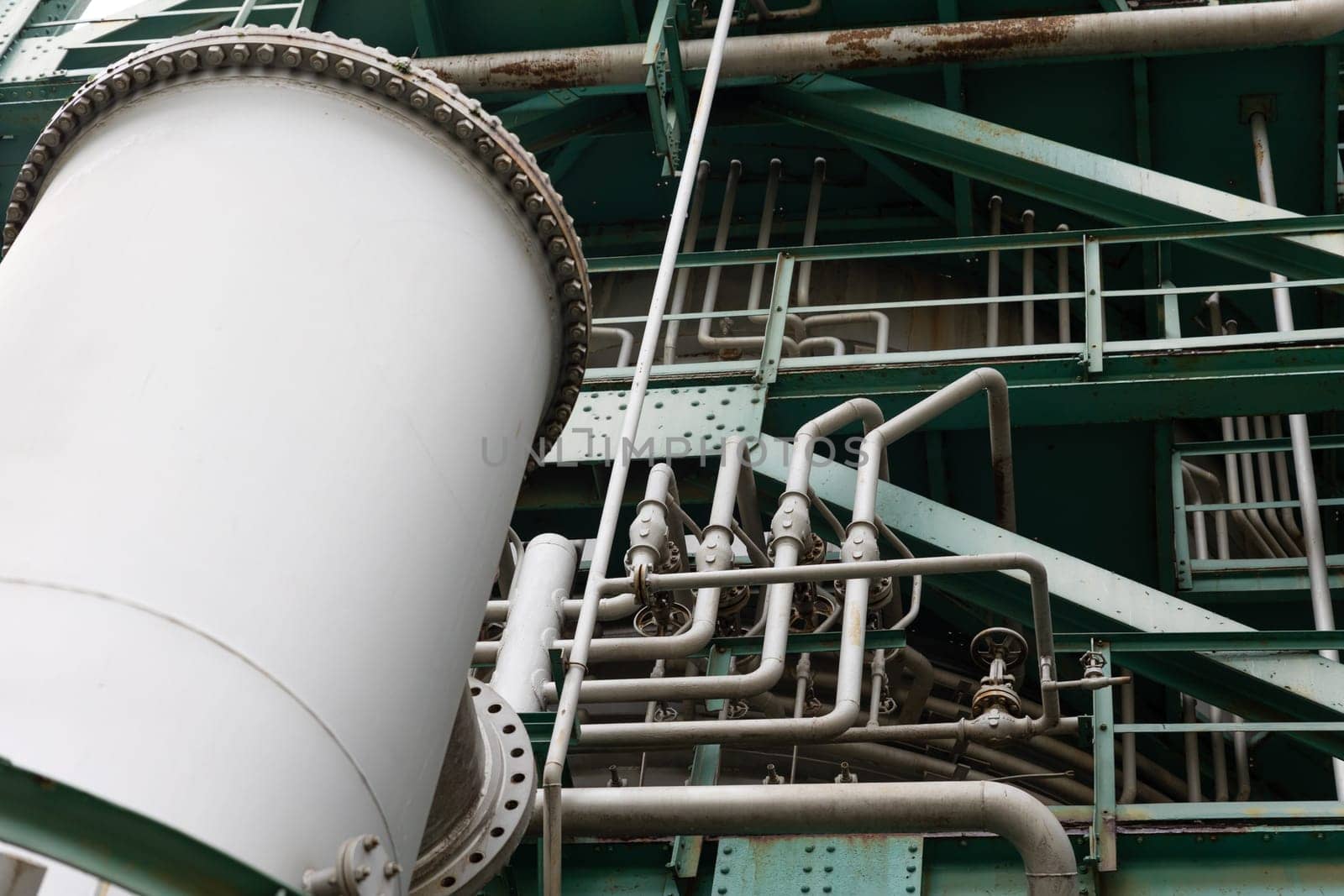 Lots of pipes on the surface of the oil and gas refining tower. Mid shot