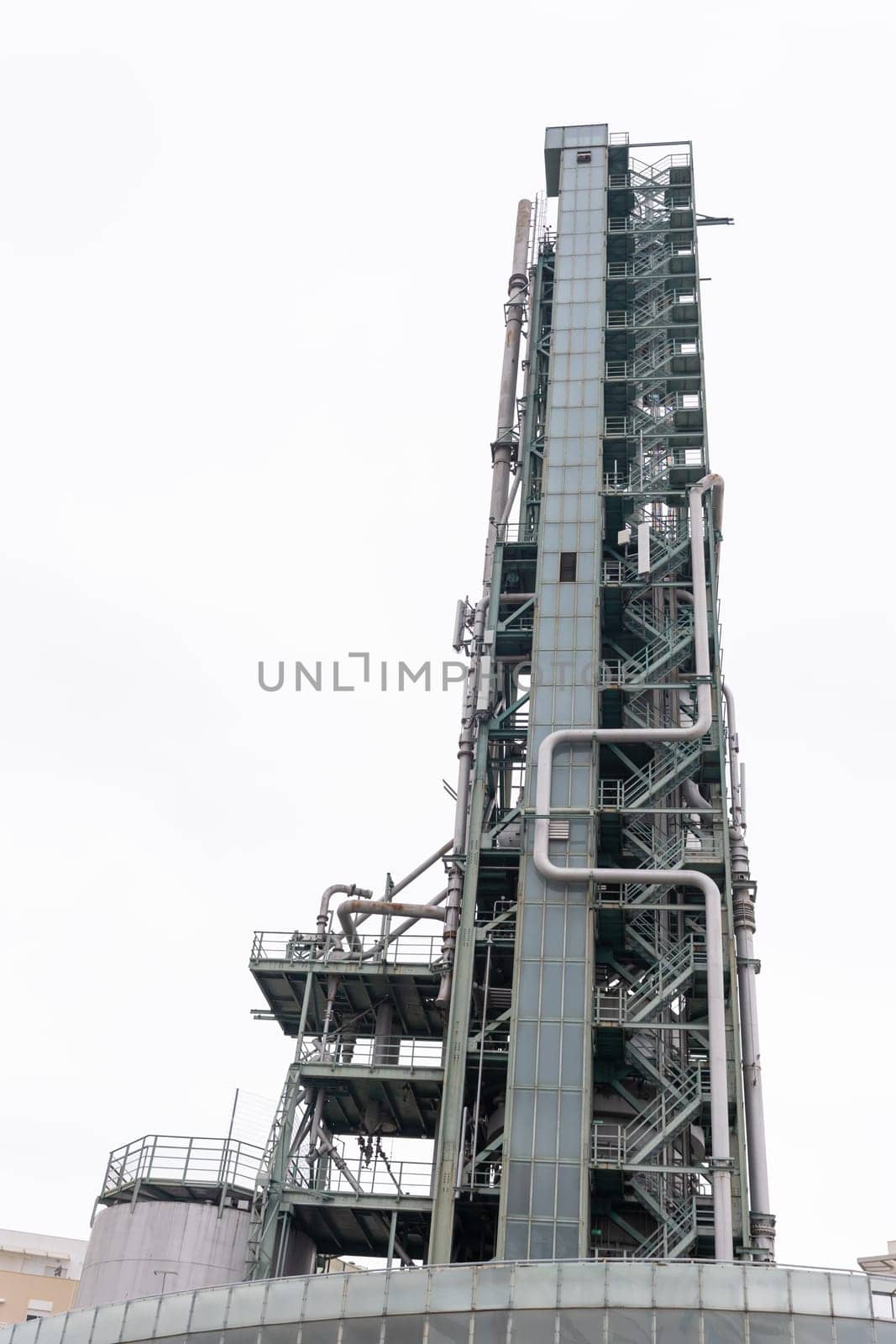 Tall tower for oil and gas refining. Vertical shot