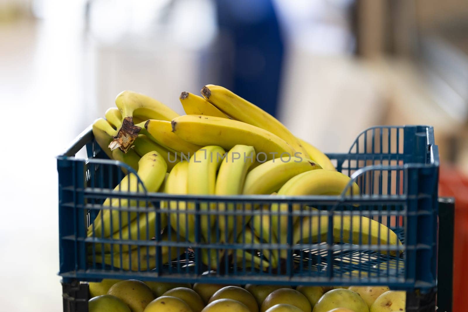 Plastic containers with bananas on the market. Mid shot