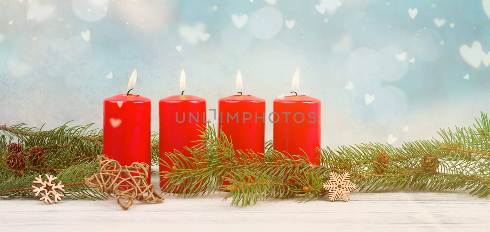 Red candles on a advent wreath with fir, christmas decoration with candlelight, winter holiday greeting card