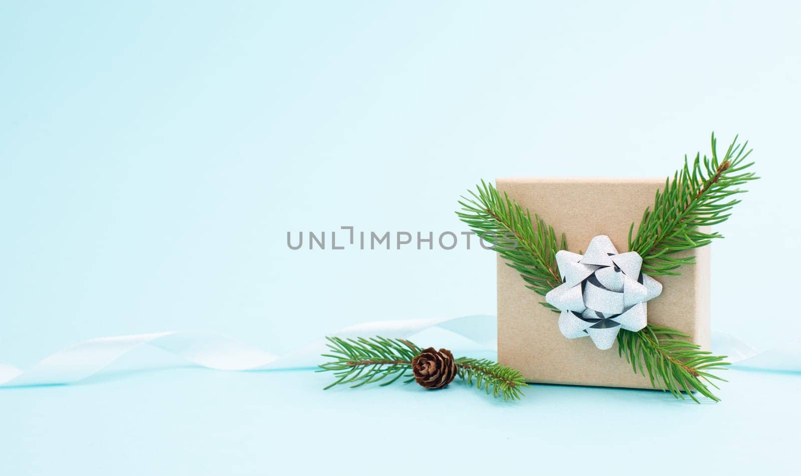 Christmas holiday greeting card with little gift boxes, stars and fir branches, blue background