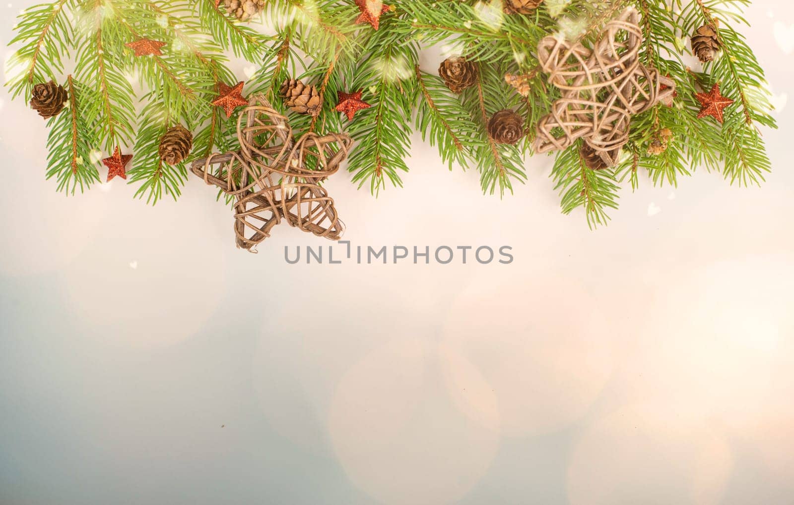 Christmas holiday background, fir branches, red stars and cones, winter season greeting card with bokeh lights and copy space