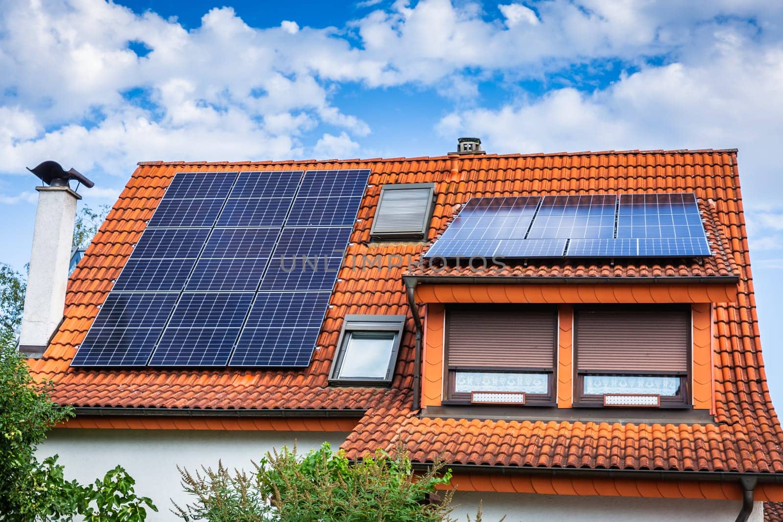 Photovoltaic panels on the roof of family house, solar panels. Environment and technology concepts.