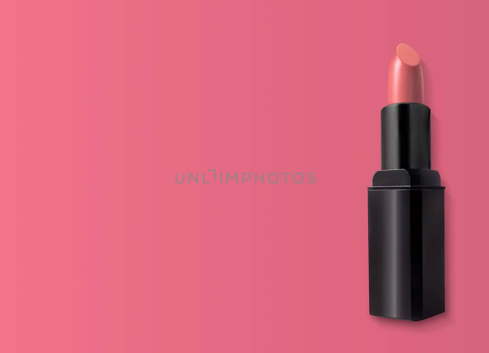 Beautiful lipstick on pink background. Makeup product