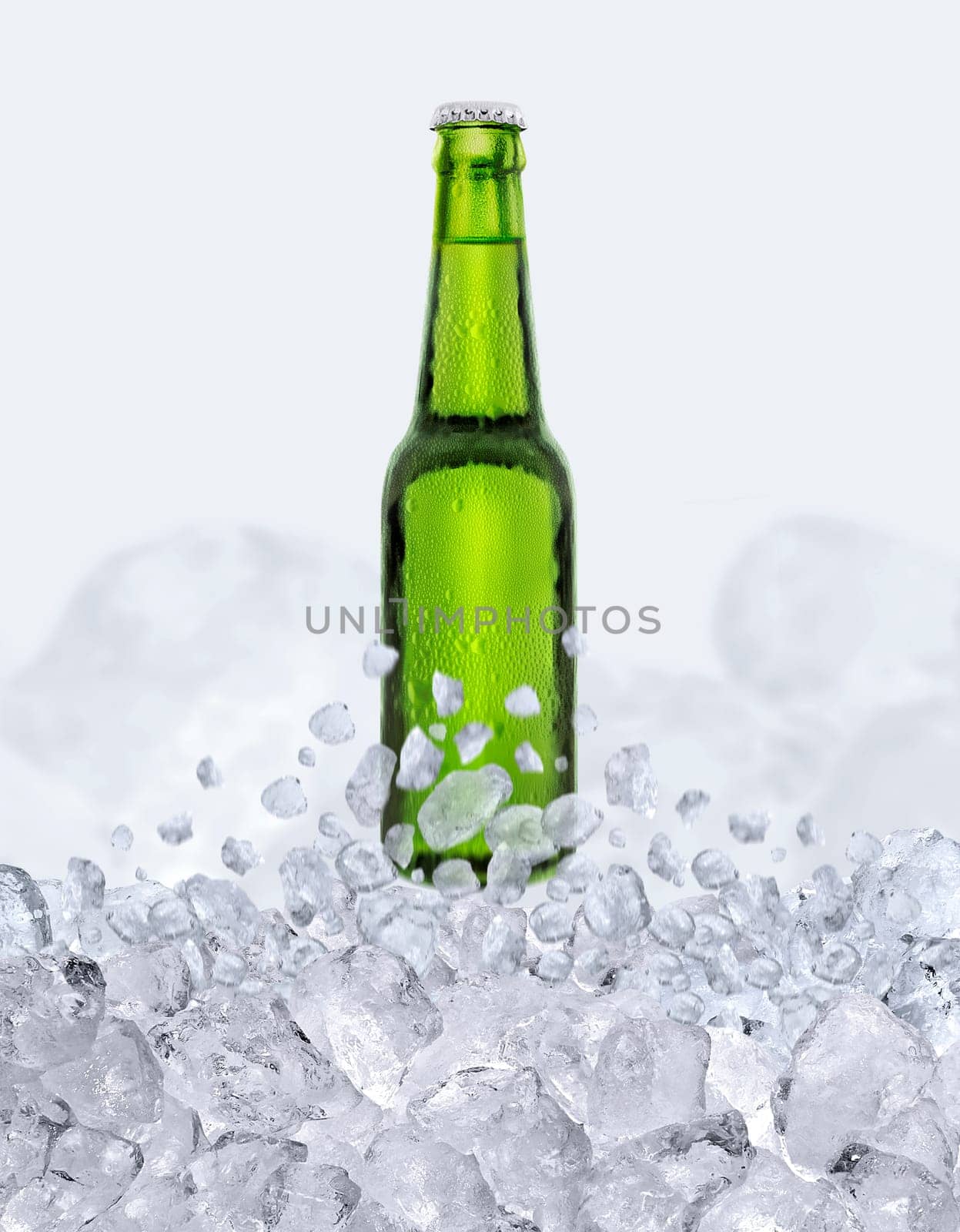 Green bottle of fresh beer with drops floats up through the ice cubes
