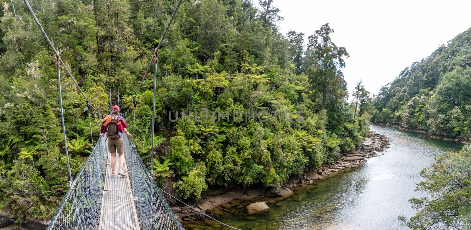 Crossing a suspension footbridge at Abel Tasman Cost Track
