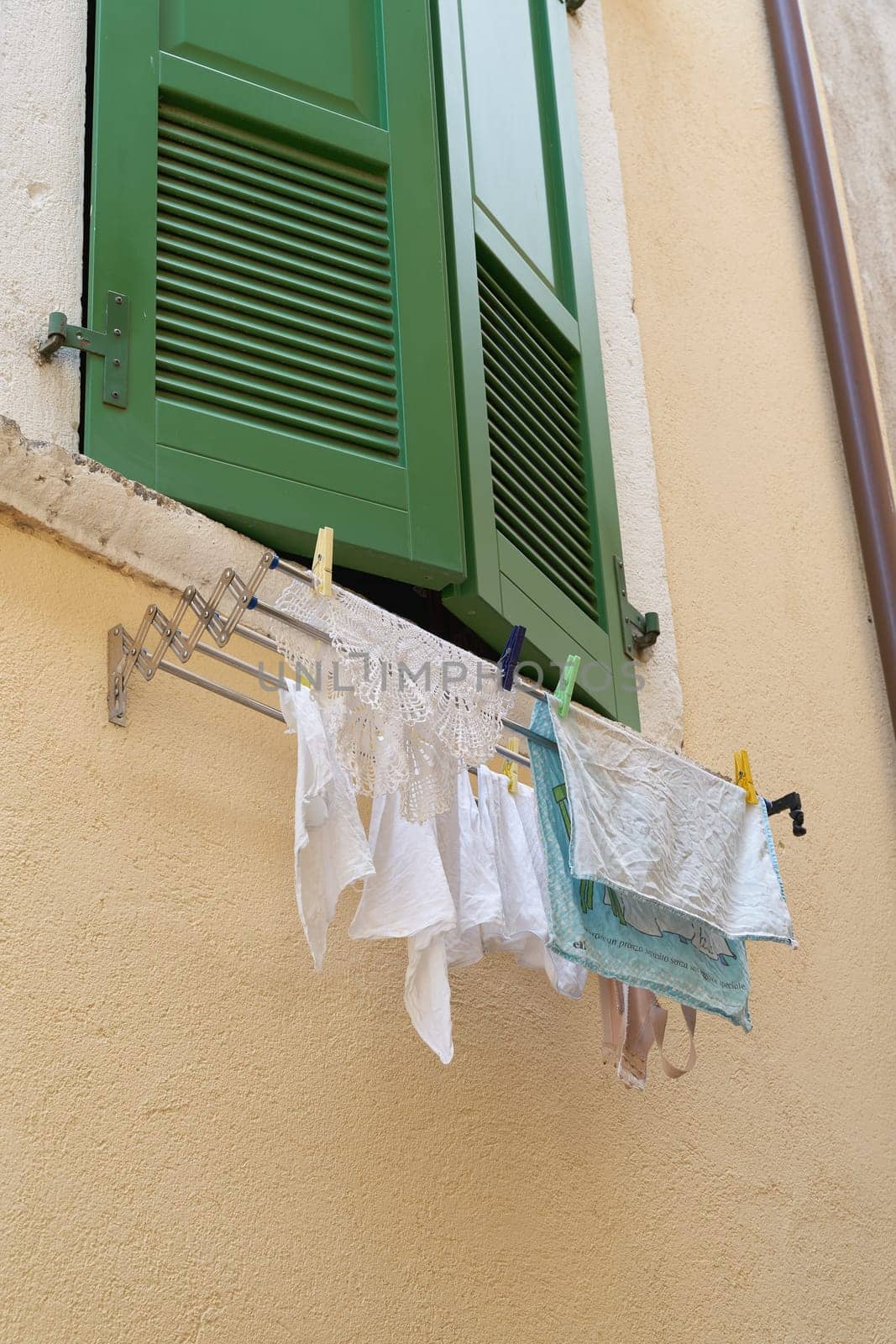 hanging laundry on the window of a house in the old town of Limone Sul Garda on Lake Garda in Italy