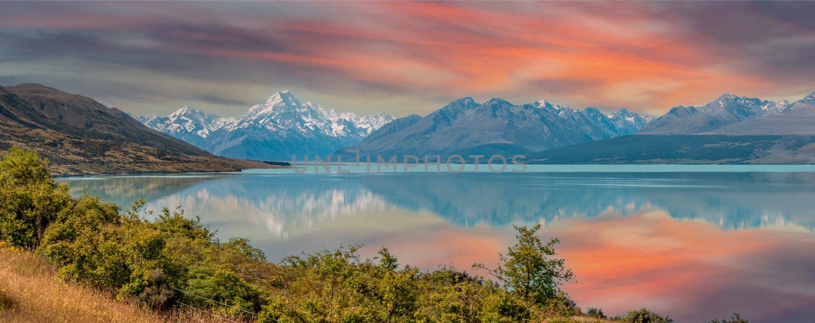 Scenic reflection of Mount Sefton and Mount Cook at lake Pukaki, South Island of New Zealand