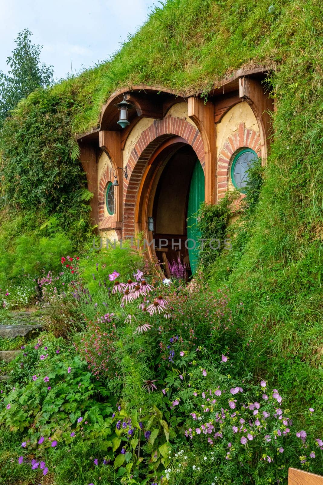 HOBBITON, NEW ZEALAND - JANUARY 20, 2023 - Bilbo Baggin's hobbit hole in Hobbiton village from the movies The Hobbit and Lord of the Rings, New Zealand