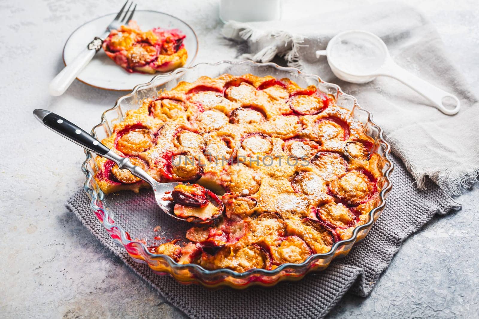 Flaugnarde or Clafoutis - French dessert with plums, large pancake baked in oven