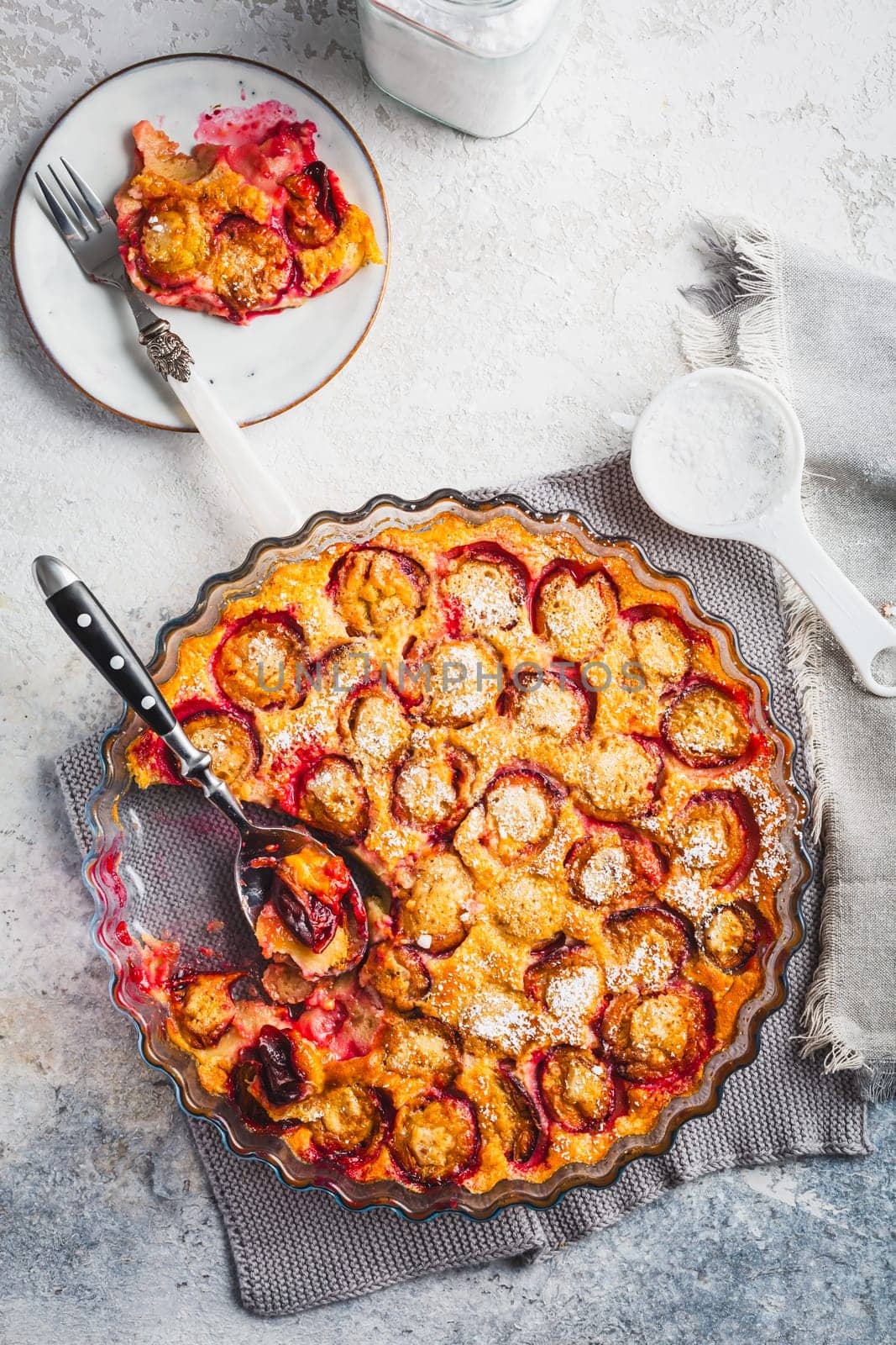 Flaugnarde or Clafoutis - French dessert with plums, large pancake baked in oven