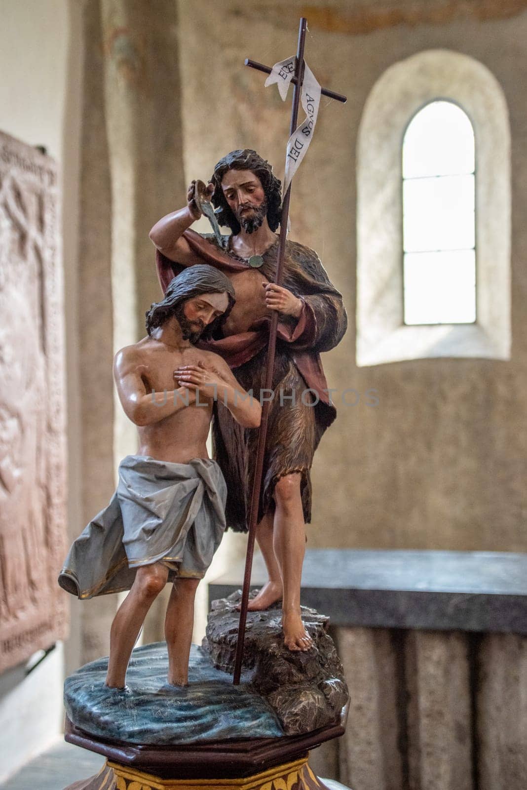 ZELL AM SEE, AUSTRIA - AUGUST 20, 2021: A small sculpture of John the Baptist and Jesus in the little church Saint Hippolyth, Zell am See in Austria