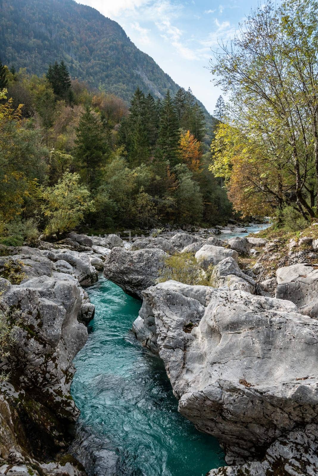 The Soca river flowing through a wild mountain landscape of the Julian Alps, Slovenia