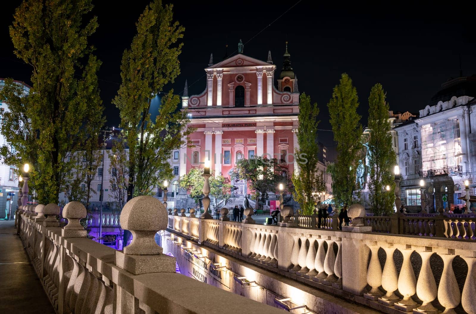Famous Three Bridges and the Preseren square in the center of Ljubljana illuminated at night, Slovenia