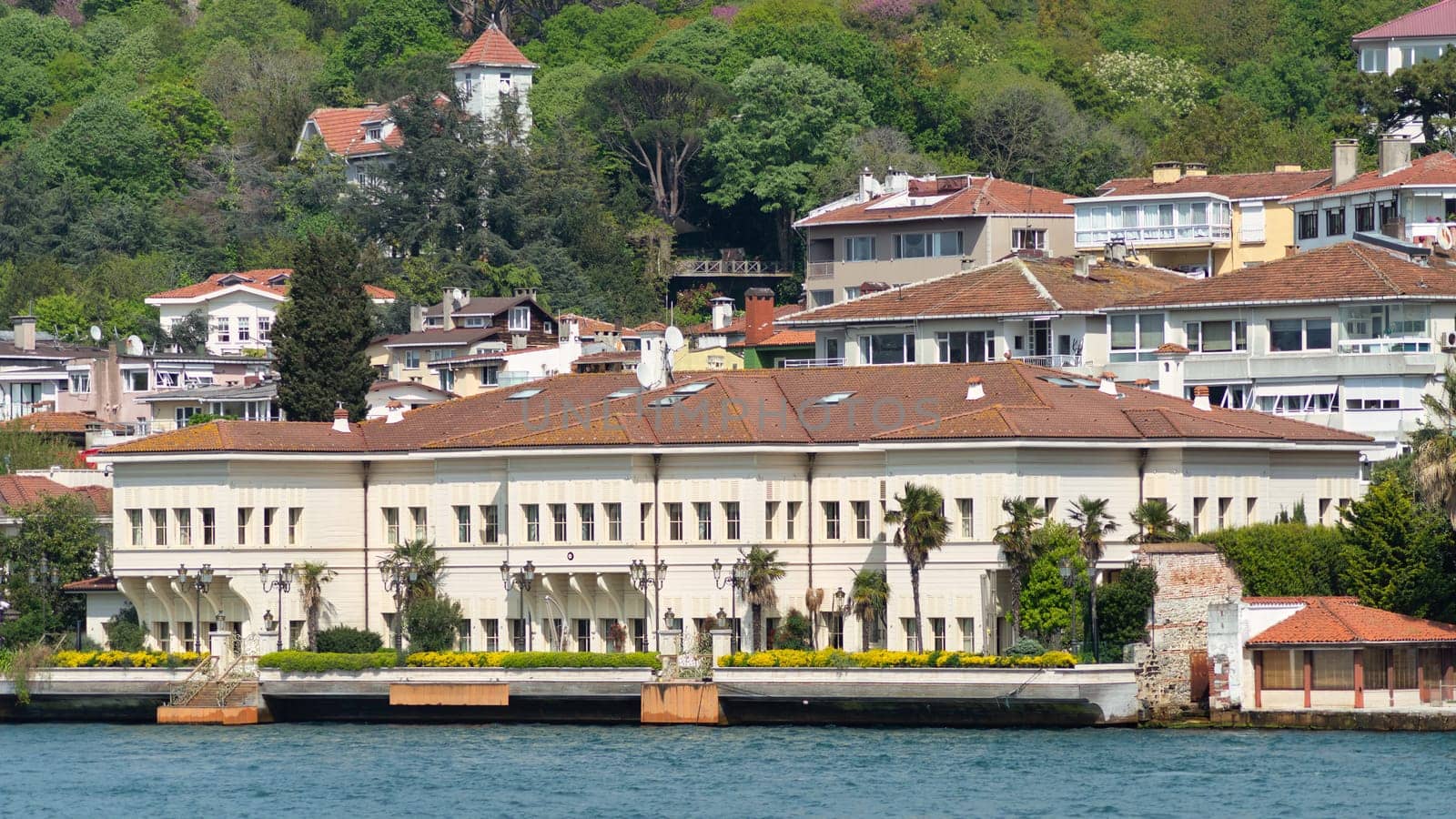 View from the sea of Saffet Pasa Mansion, with the green mountains of the Europian side of Bosphorus in the background, with dense trees, Istanbul, Turkey