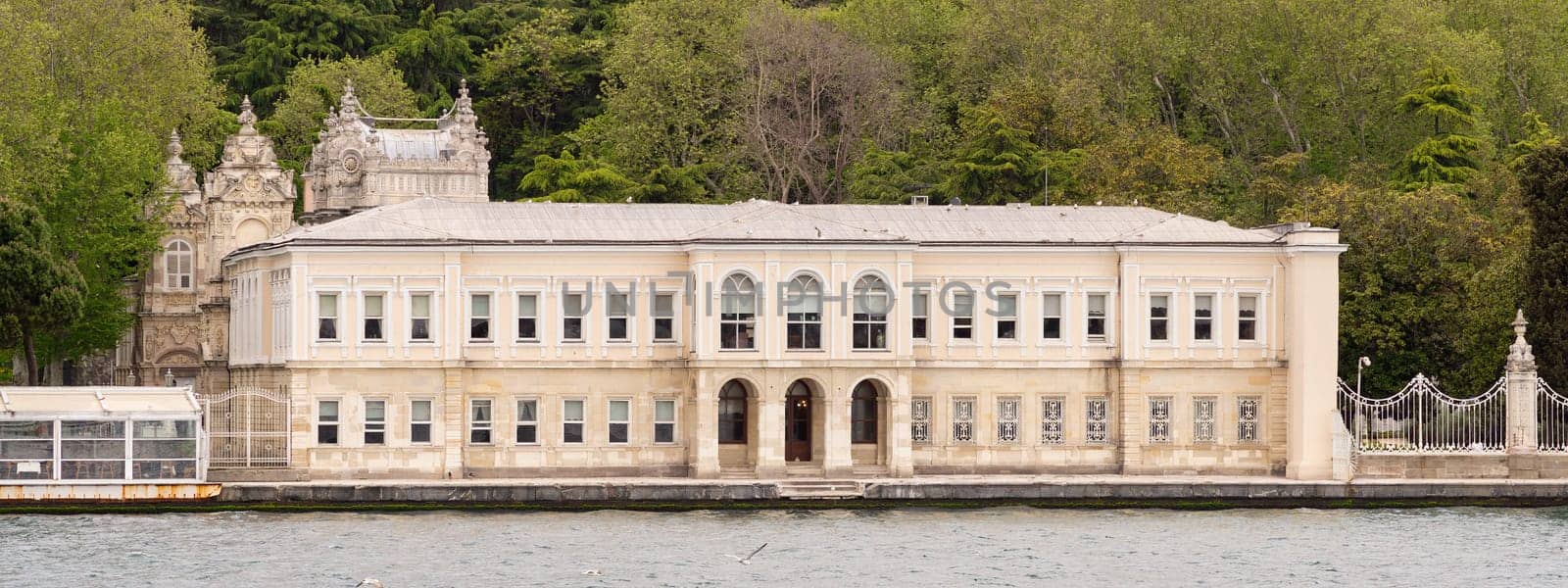 View from Bosporus strait of one of the buildings of Dolmabahce Palace, or Dolmabahce Sarayi, located in Besiktas district on the European coast, Istanbul, Turkey