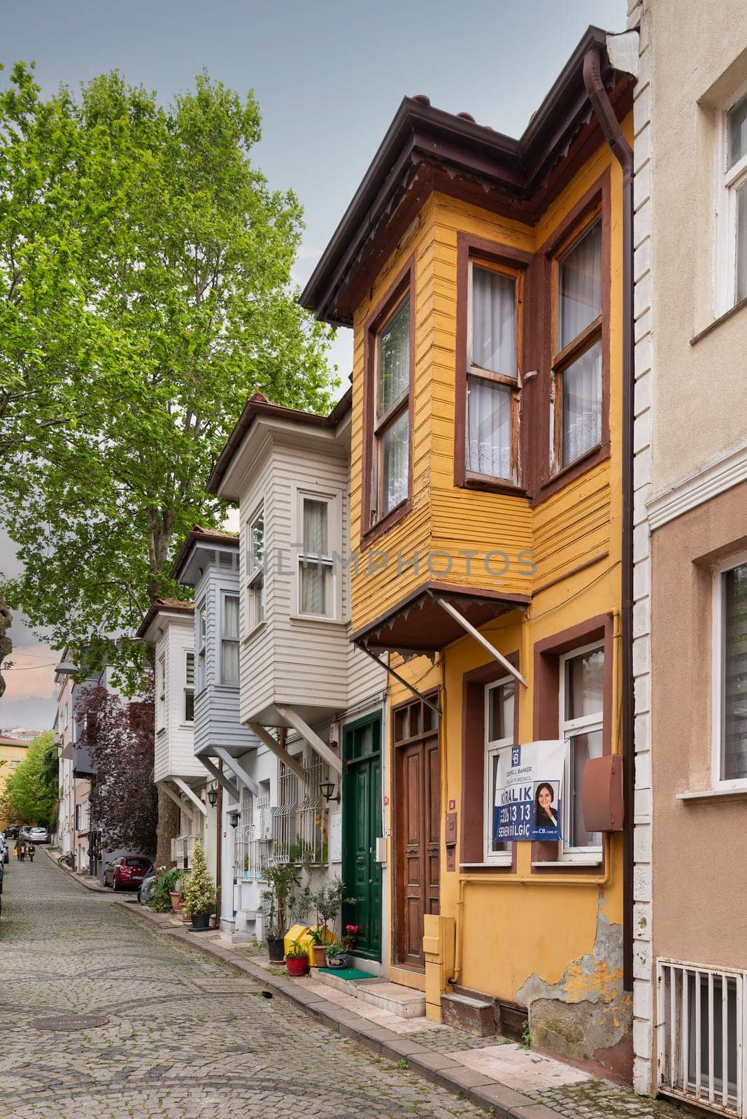 Istanbul, Turkey - May 9, 2023: Narrow cobblestone alley with colorful wooden houses, suited in Kuzguncuk neighborhood, Uskudar district