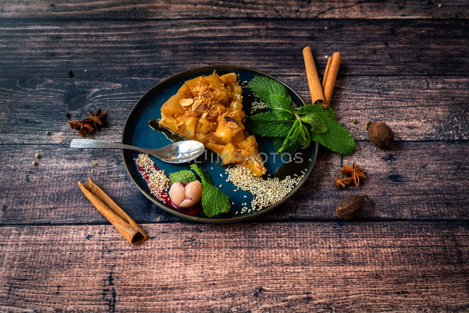 Famous slice of tarte tatin with lechee and mint leaves