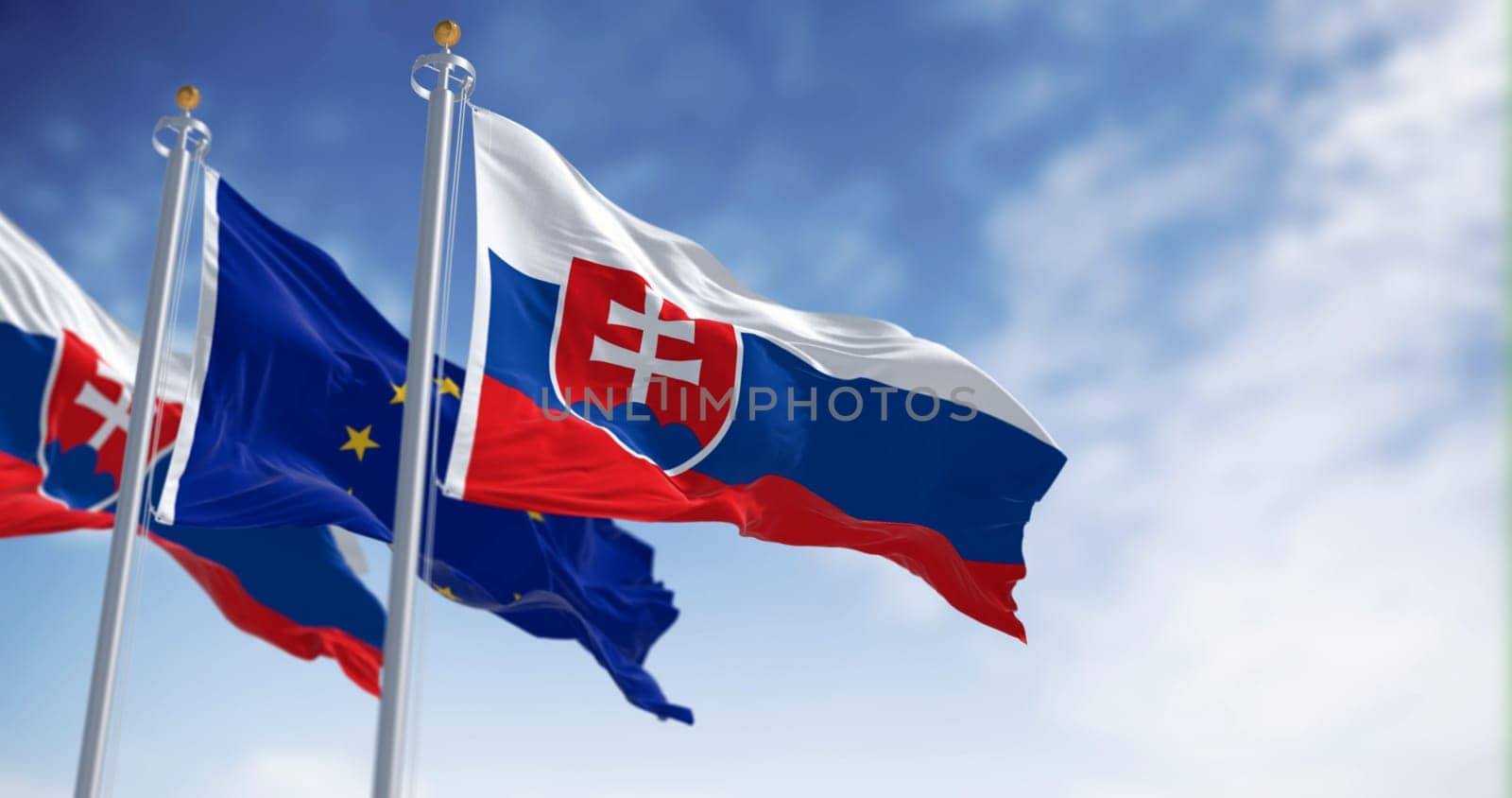 The flags of Slovakia and the European Union fluttering together on a clear day. Slovakia has been a member of the eurozone since January 1, 2009. 3D illustration render. Fluttering fabric