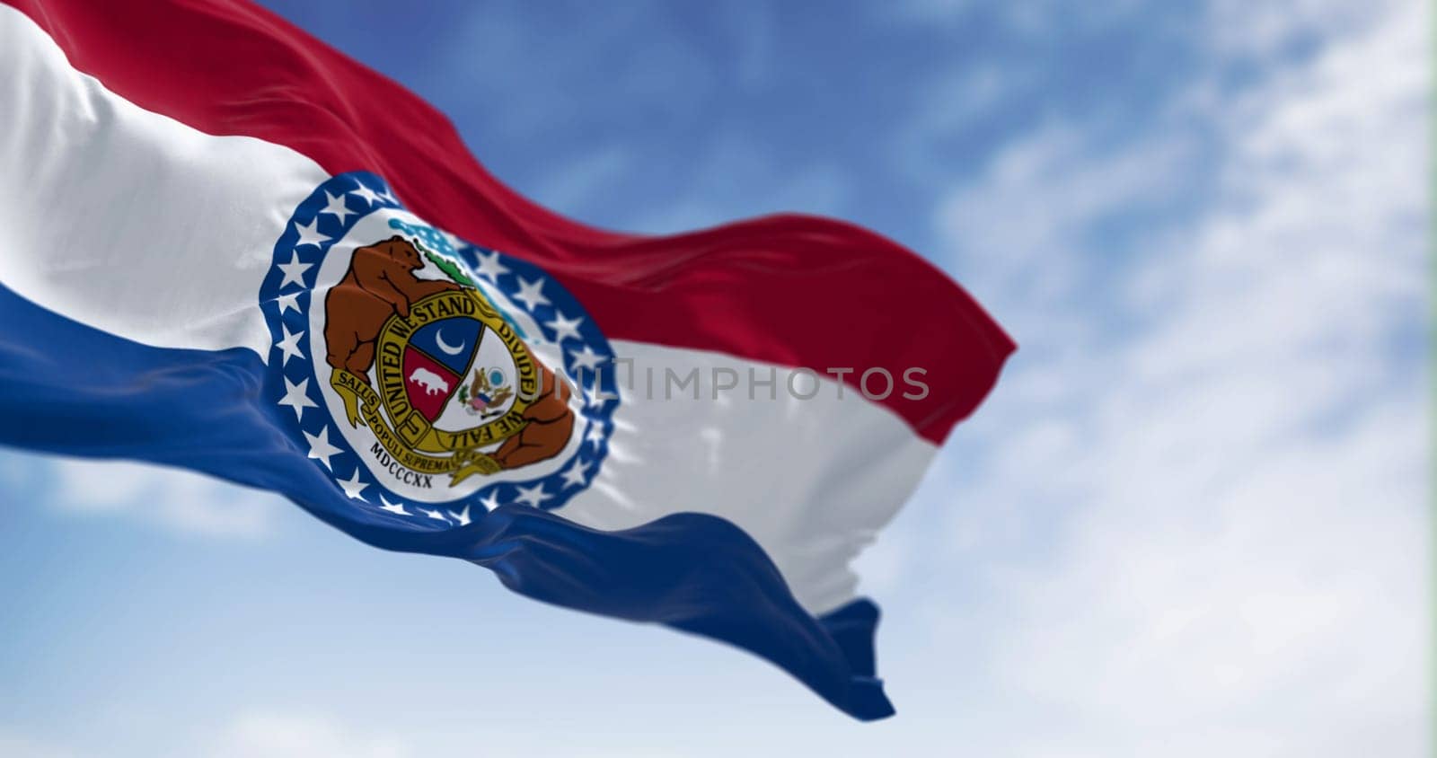 Missouri state flag waving on a clear day. Red, white, blue horizontal stripes with Great Seal of Missouri in center. 3d illustration render. Textured background. Selective focus. Fluttering textile