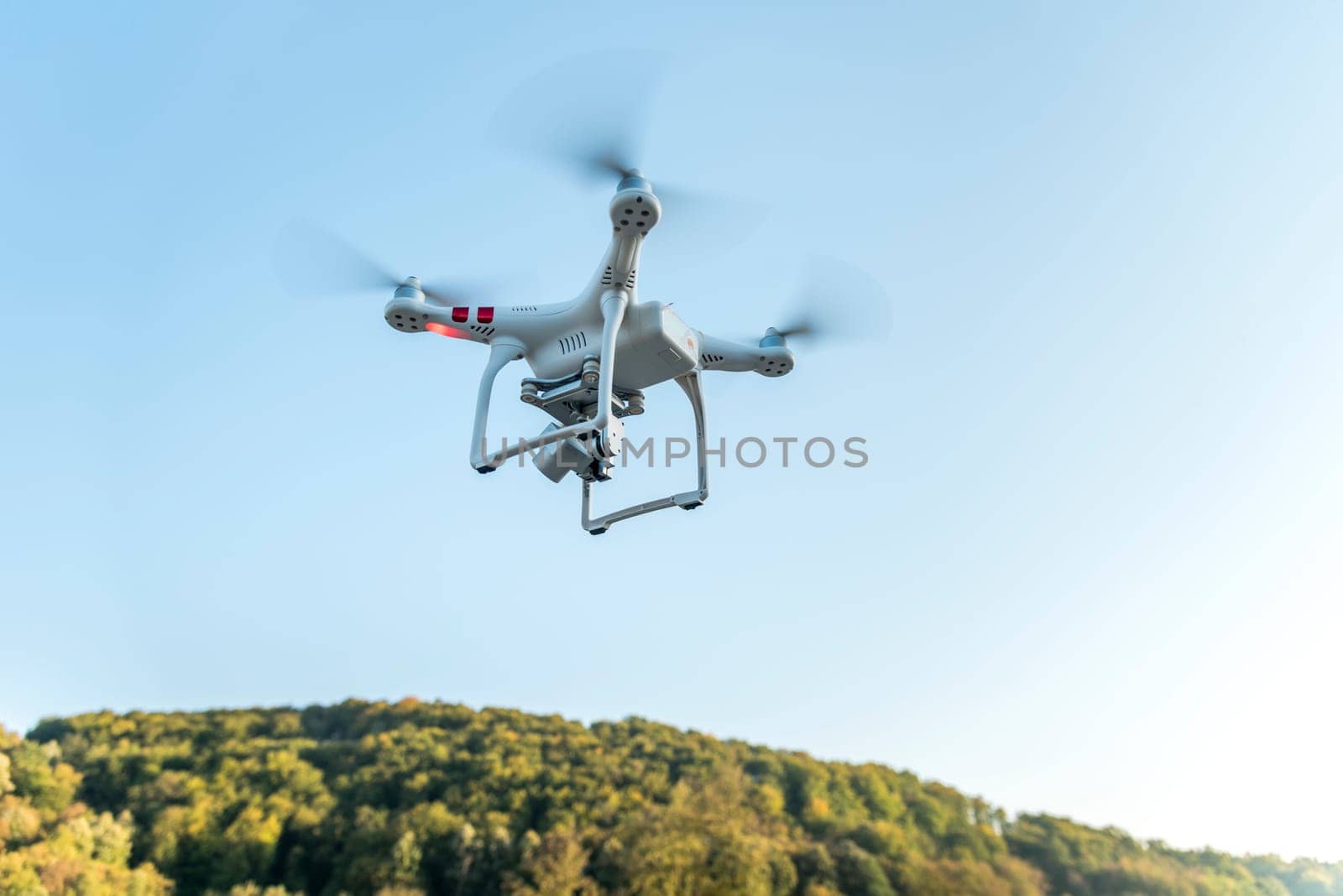 Drone with digital camera flying in the sky. Modern technology for aerial video and photography.