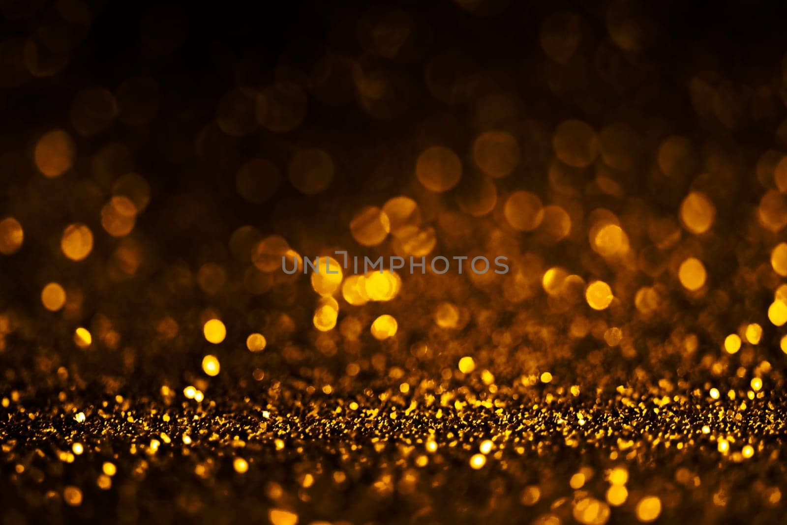 Blur gold light circle background. Sparkling firework bokeh dots on dark wall. Luxury and classy new year and christmas celebration party textured backdrop. Blurry golden dust frame design.