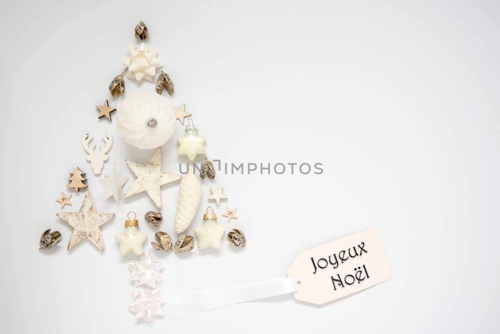 Whiter Background With A Christmas Tree Out Of Christmas Decoration, With A Label With French Text Joyeux Noel, Which Means Merry Christmas In English