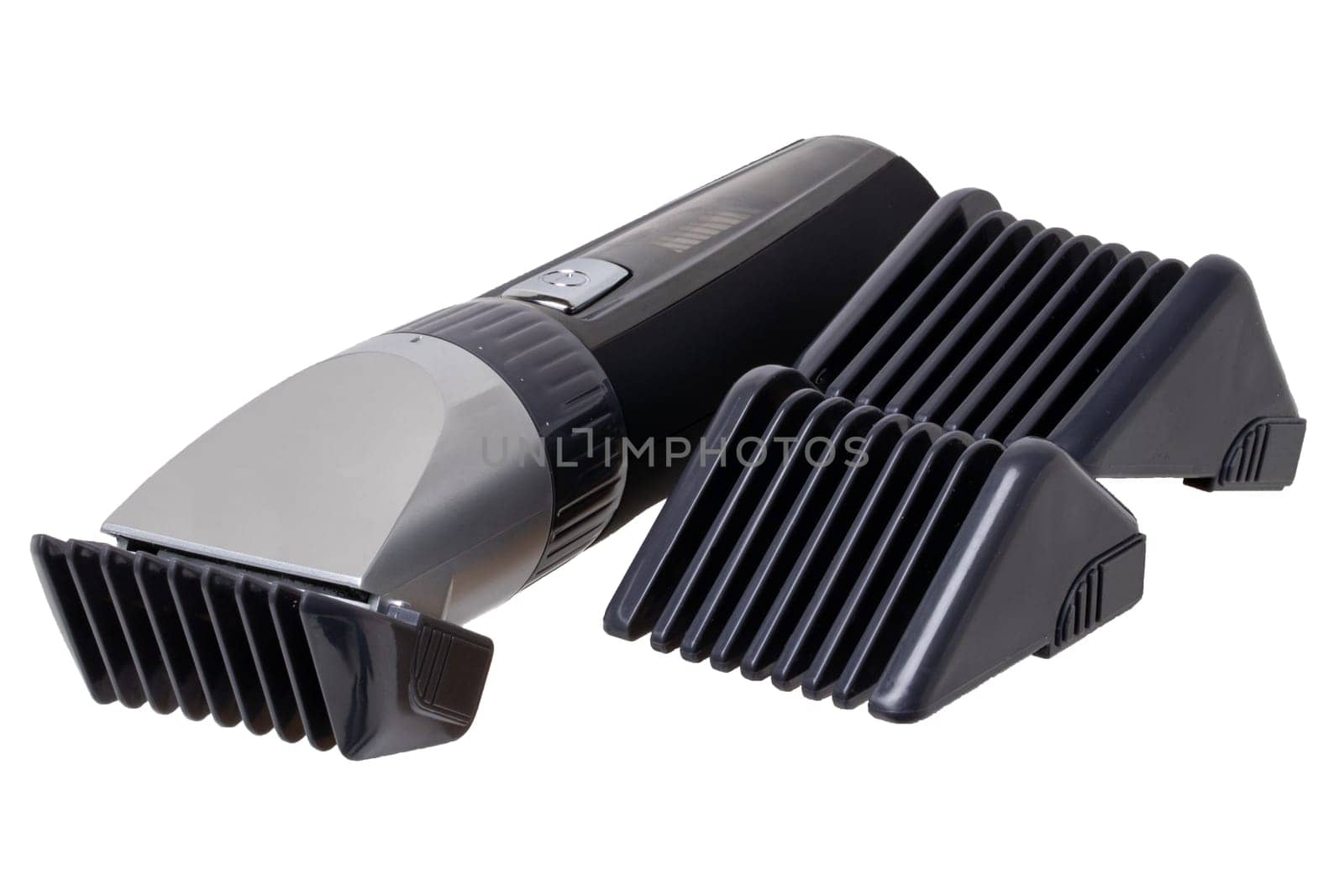 Close-up of a new black silver rechargeable beard and hair clipper with two attachment objects isolated on white. Cordless hair and beard trimmer. Macro.