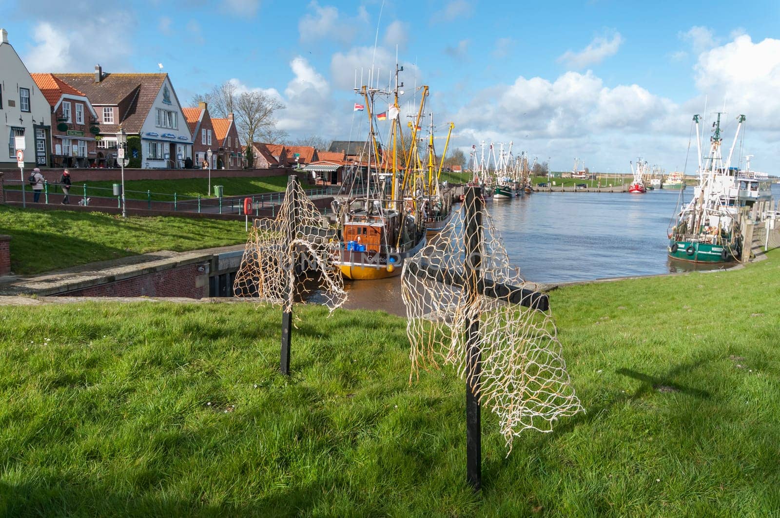 Carolinensiel, Germany - March 27, 2023: Set up crosses with fishing net parts in the port of Carolinensiel during an action against severely limited fishing quotas.