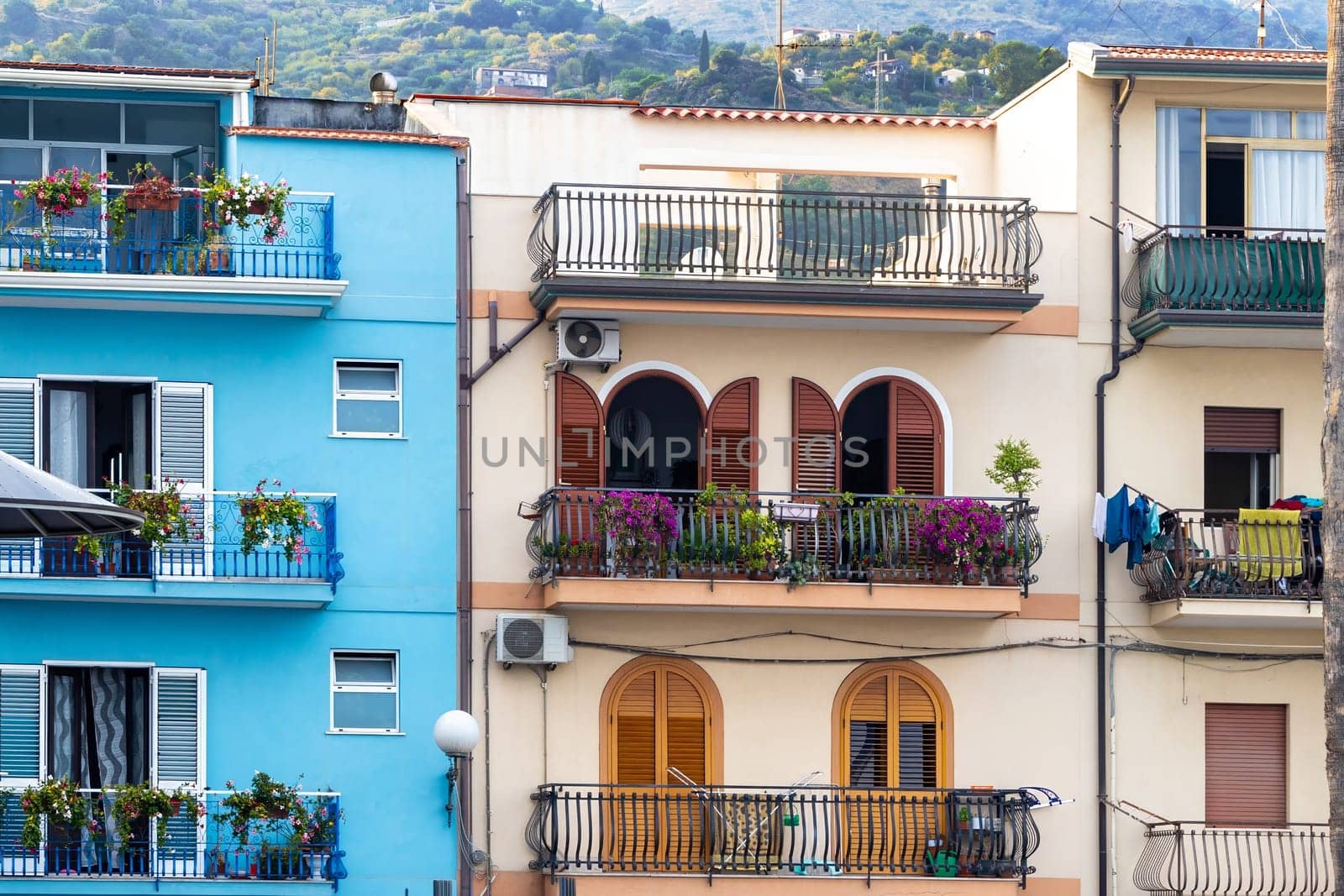 Giardini Naxos in Sicily Italy 08.11.2022 - Multicolored traditional houses with balconies in the port area
