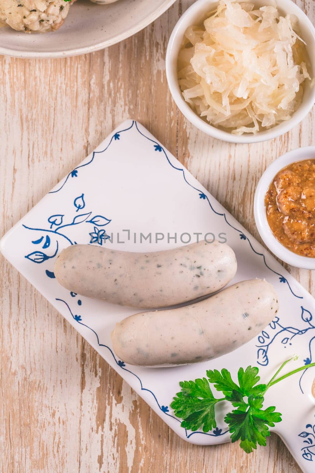 Bavarian white sausages with sauerkraut and bread dumplings, with mustard.